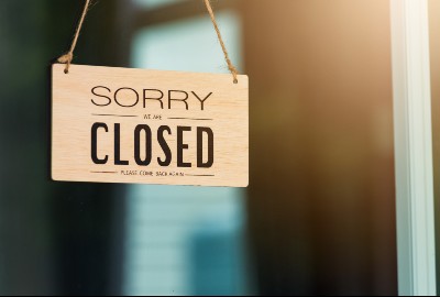 woman closing store regarding the business support scheme