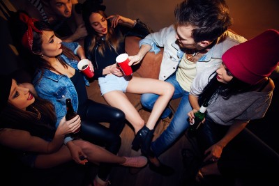 People hang out at a house party - super-spreader events