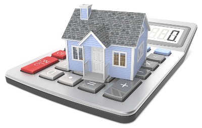 Model of a house sits on top of a desk calculator - mortgage holiday