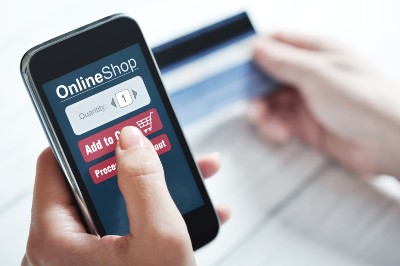Woman uses smartphone to shop online