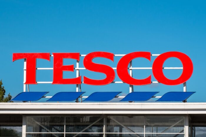 Tesco supermarket sign atop a store exterior