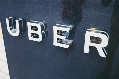 An Uber sign at a pickup point - London license