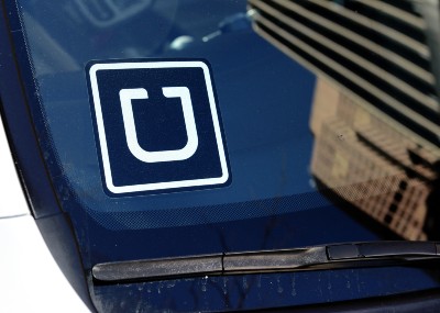 An Uber decal is shown in the corner of a car windshield - london licence