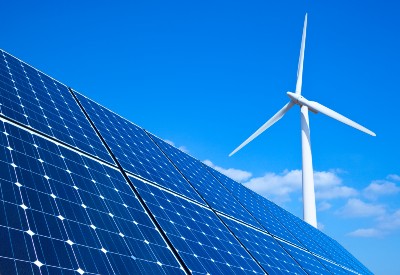 Windmill and solar panel against partly cloudy blue sky - Bulb