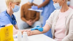 Woman getting COVID-19 vaccine regarding its legal indemnity