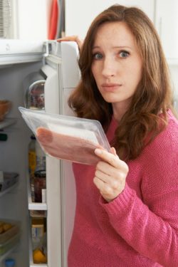 Woman throwing out meat regarding recall